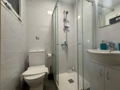 a bathroom with a shower and a toilet and a sink at Appartments 750m from beach, tourist area in Limassol