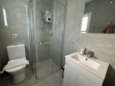 a bathroom with a shower and a toilet and a sink at Appartments 750m from beach, tourist area in Limassol