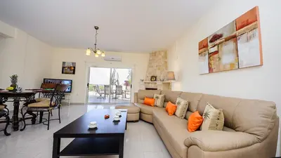 a living room with a couch and a table at Protaras Holiday Villa 196 in Protaras