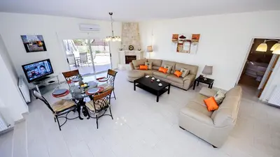 a living room with a couch and a table at Protaras Holiday Villa 196 in Protaras