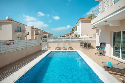 a swimming pool in the backyard of a house at Pernera Holiday Villa 173 in Protaras