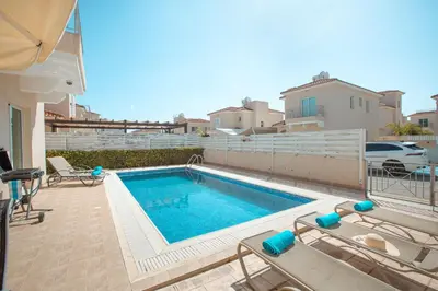 a swimming pool in the backyard of a house at Pernera Holiday Villa 173 in Protaras