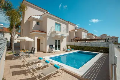 a villa with a swimming pool and a house at Pernera Holiday Villa 173 in Protaras