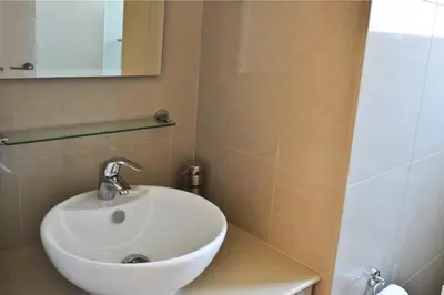a bathroom with a white sink and a mirror at Pernera Holiday Villa 173 in Protaras