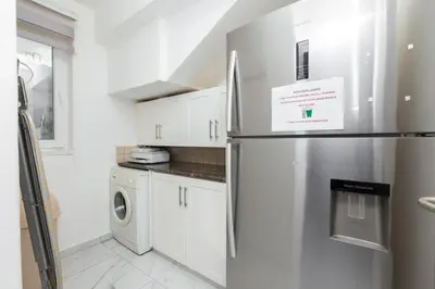 a kitchen with a refrigerator with a sign on it at Protaras Holiday Villa 113 in Protaras