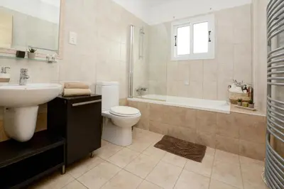 a bathroom with a sink and a toilet and a bath tub at Villa Thetida in Ayia Napa