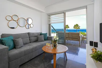 a living room with a couch and a table at Jenny - Beachfront Apartment in Protaras