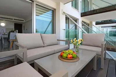 a living room with a couch and a table with fruit on it at Jenny - Beachfront Apartment in Protaras