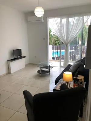 a living room with a couch and a table at A+A Apartment in Kiti