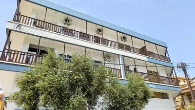 an apartment building with balconies and a tree at Heaven City Apartment, 150m from Chabad Lubavitch in Larnaka