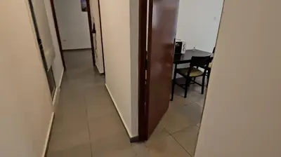 a hallway with a table and a room with a mirror at Heaven City Apartment, 150m from Chabad Lubavitch in Larnaka