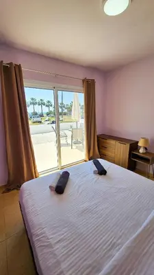 a bedroom with a bed with a view of the beach at Beach Love BeachFront Apartment in Pyla