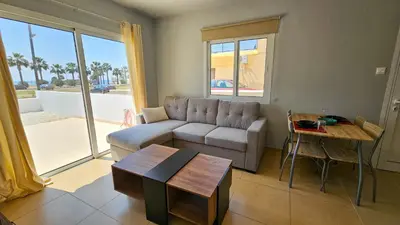 a living room with a couch and a table at Beach Love BeachFront Apartment in Pyla