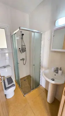 a bathroom with a shower and a toilet and a sink at Beach Love BeachFront Apartment in Pyla