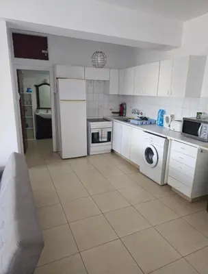 a kitchen with a washer and dryer in it at The Heart of the City in Limassol