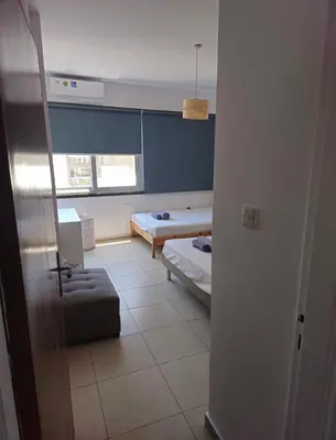 a room with a bedroom with a bed and a couch at The Heart of the City in Limassol