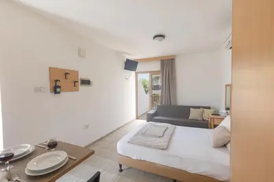 a white room with a bed and a couch at Pernera Nest in Protaras