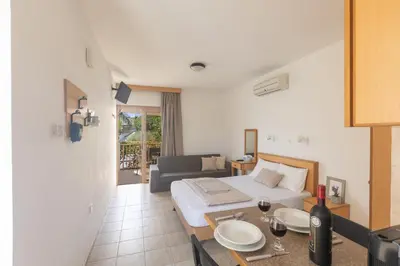 a bedroom with a bed and a table with wine glasses at Pernera Nest in Protaras
