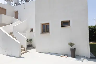 a white house with stairs and potted plants at Pernera Nest in Protaras