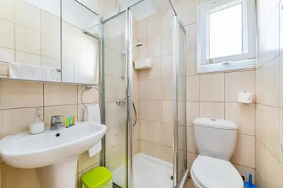a bathroom with a toilet and a sink and a shower at Villa Amesta in Protaras