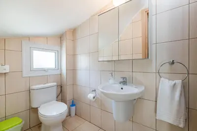 a bathroom with a toilet and a sink at Villa Amesta in Protaras
