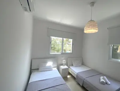 a bedroom with two beds and a pendant light at DPSAE09 Mythical Sands Resort - Two Bedroom Apt with pool in Paralimni