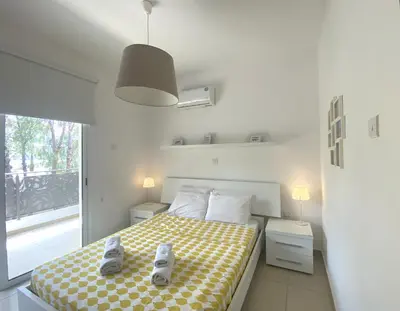 a bedroom with a bed with shoes on it at DPSAE09 Mythical Sands Resort - Two Bedroom Apt with pool in Paralimni