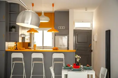a kitchen with a counter with chairs and a kitchen island at Protaras O2 Seaside Suite in Protaras