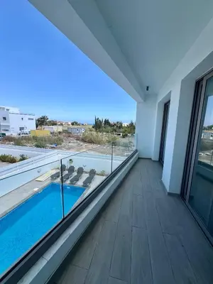 a room with a view of a swimming pool in a building at Hubstay - Seaview Villa Oriana in Larnaca in Larnaka