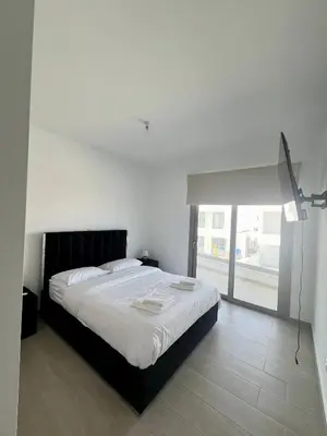 a white bedroom with a large bed and a window at Hubstay - Seaview Villa Oriana in Larnaca in Larnaka