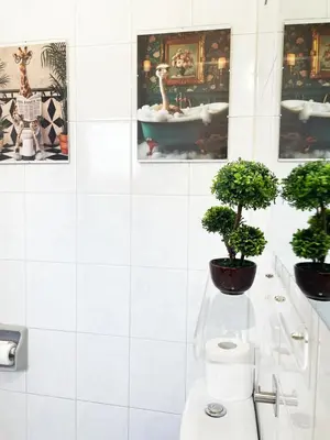 a bathroom with two potted plants and a toilet at Large apartment close to Finikoudes Beach with 2 balconies in Larnaka