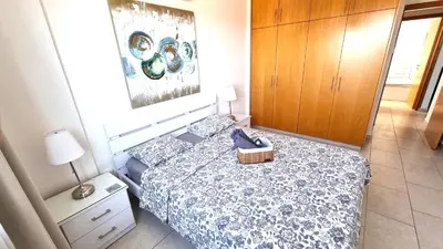 a bedroom with a bed with a basket on it at Beach Haven: 7-Minute walk to the beach + Pool in Larnaka