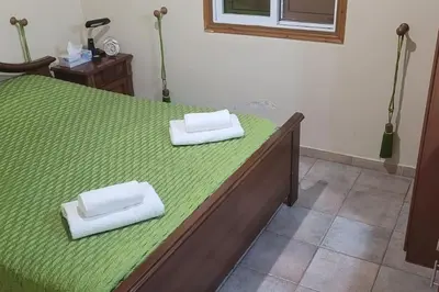 a bed with two white towels on top of it at Despol Villa in Alaminos