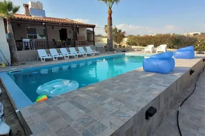 a pool with chairs and a swimming pool at Despol Villa in Alaminos