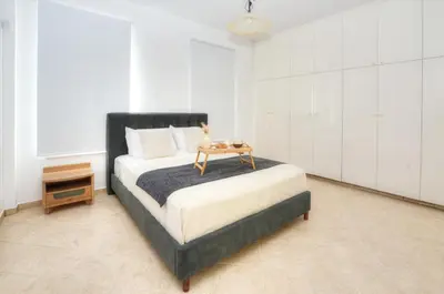 a bedroom with a bed with a table on it at Villa Aquamarine in Ayia Napa