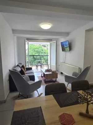a living room with a couch and chairs and a table at Maryland River Liz in Kakopetria