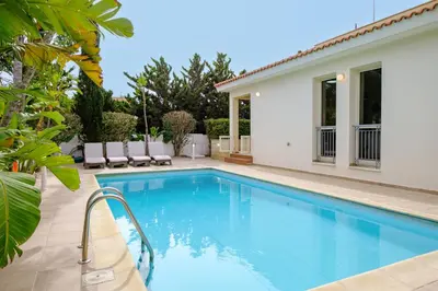 a swimming pool in the backyard of a house at Villa with private pool in Pervolia, Larnaca in Pervolia