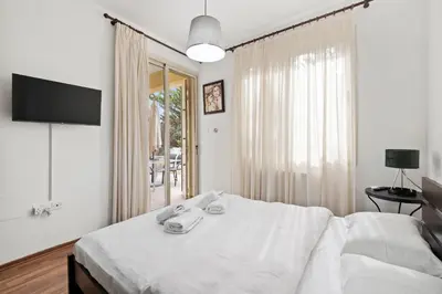 a bedroom with a bed with a television and a window at Villa with private pool in Pervolia, Larnaca in Pervolia