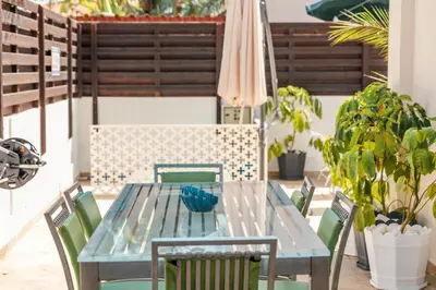 a table and chairs on a patio with an umbrella at Mermaid Villa 16 in Ayia Napa