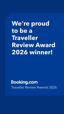 a blue sign that says were proud to be a traveller reviewagency winner at Under the Palms in Nicosia