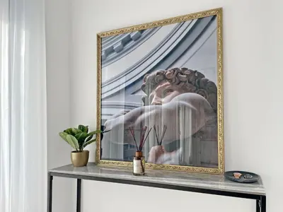 a framed picture of a statue on a table at The Encino - luxury seaside suite in Larnaka