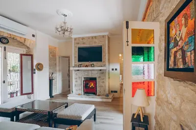 a living room with a fireplace and a tv at No 1 Mandria in Limassol