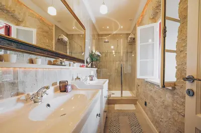 a bathroom with a tub and a sink and a mirror at No 1 Mandria in Limassol