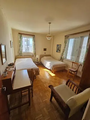 a bedroom with two beds and a table and a couch at Beautiful Apartment in Center of Nicosia with views in Nicosia