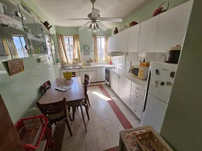 a kitchen with a table and a white refrigerator at Beautiful Apartment in Center of Nicosia with views in Nicosia