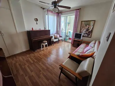a living room with a couch and a piano at Beautiful Apartment in Center of Nicosia with views in Nicosia