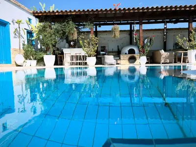 a swimming pool with blue water at Little Stone House in Lymbia