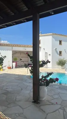 a view of a courtyard with a pool and a building at Little Stone House in Lymbia