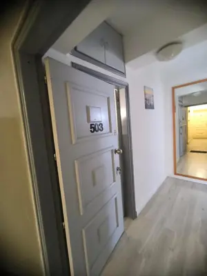 an empty room with a door with a sign on it at Sunorama Beach Garden - Seaview in Larnaka