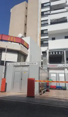 a building with a sign on the side of a street at Sunorama Beach Garden - Seaview in Larnaka
